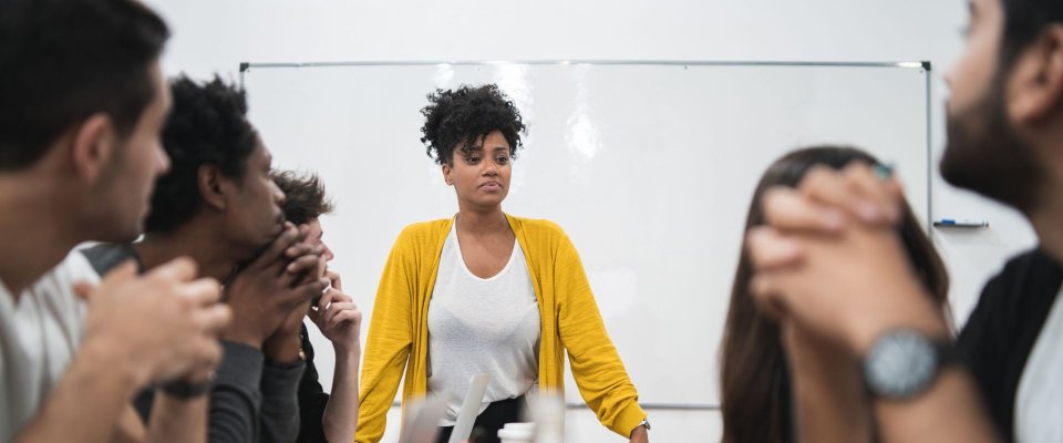Black woman leading office meeting
