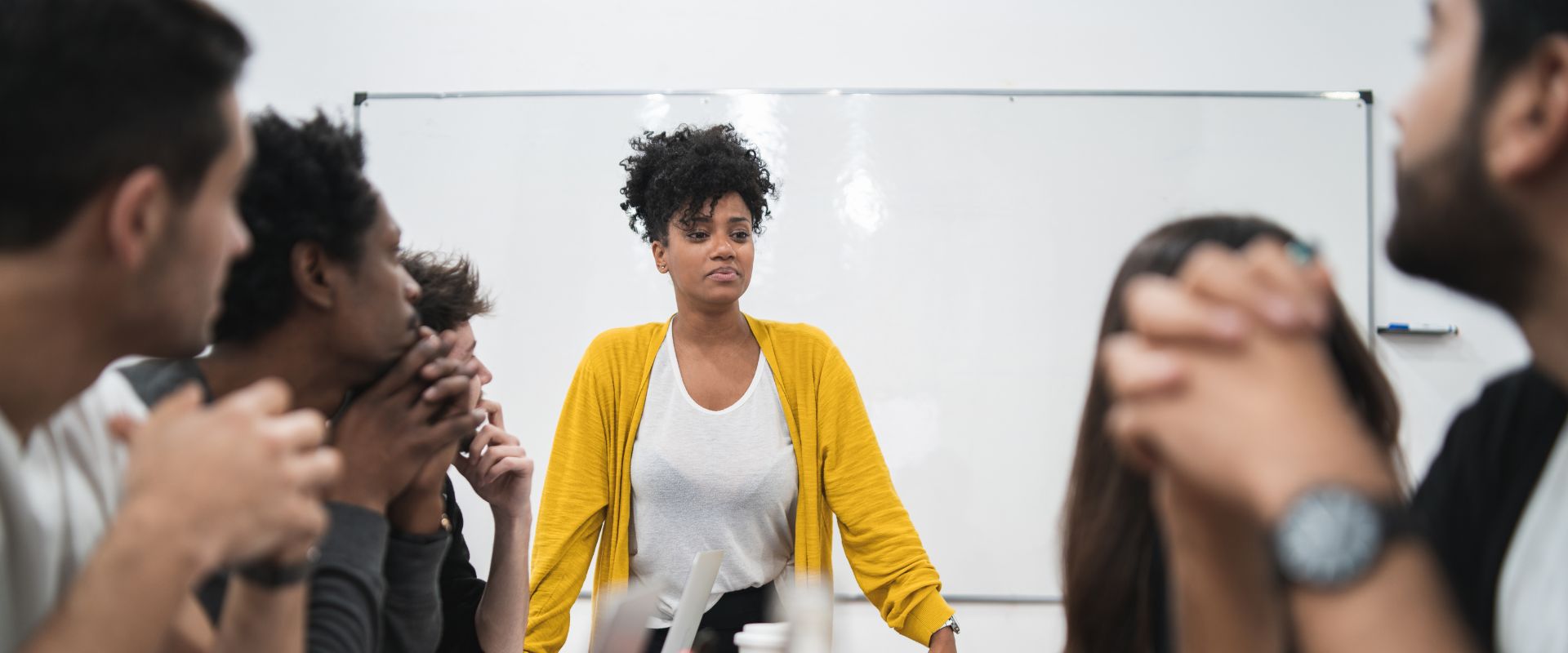 Black woman leading office meeting