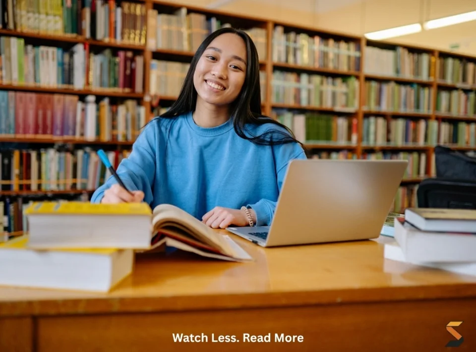 Student smiling while working