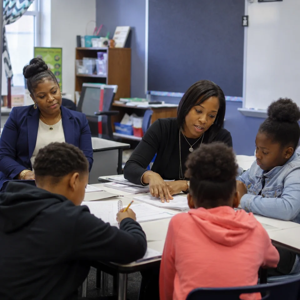 black female principal observing small-group instruction