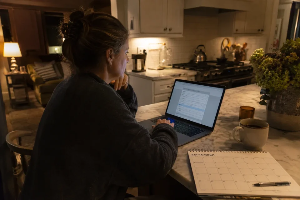 a parent at a kitchen island at night