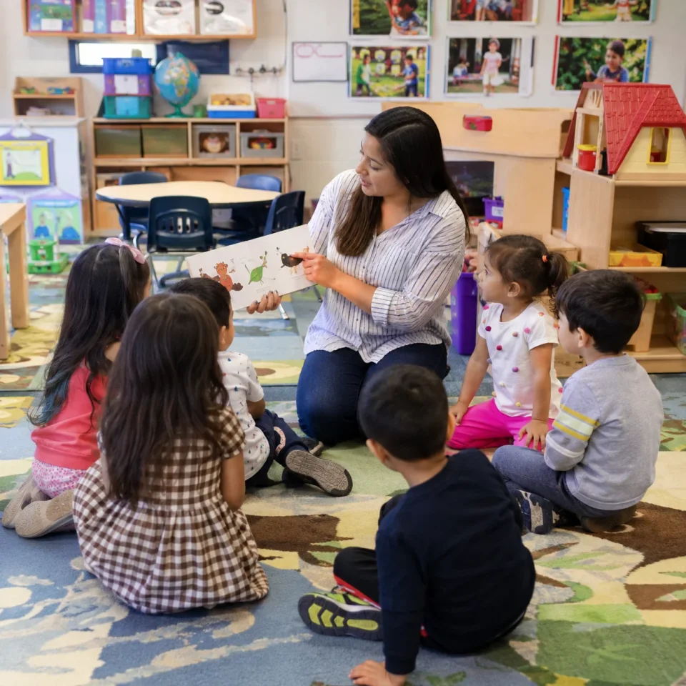 Preschool teacher in classroom with students