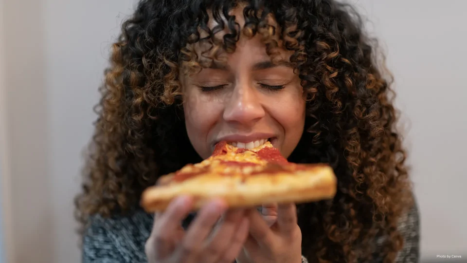 Woman eating pizza