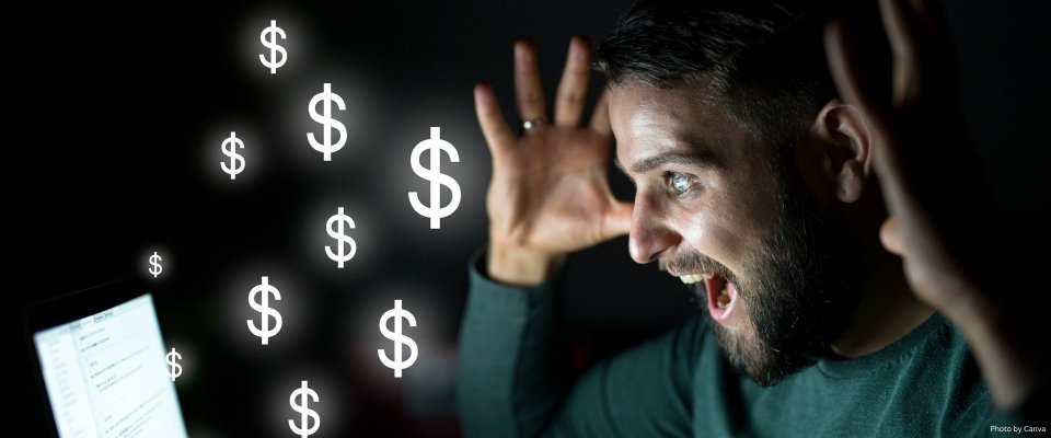 Man screaming in front of a computer