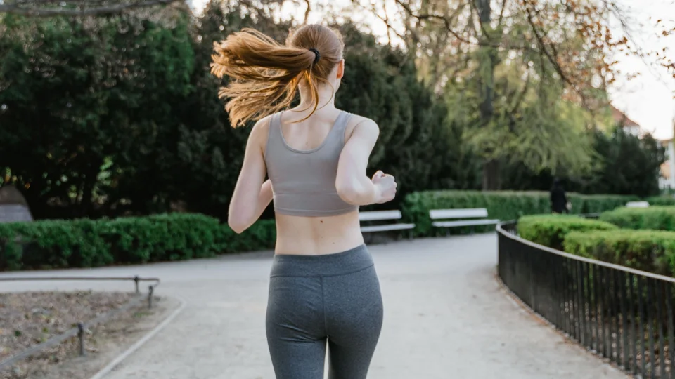Back view of a woman jogging in a park