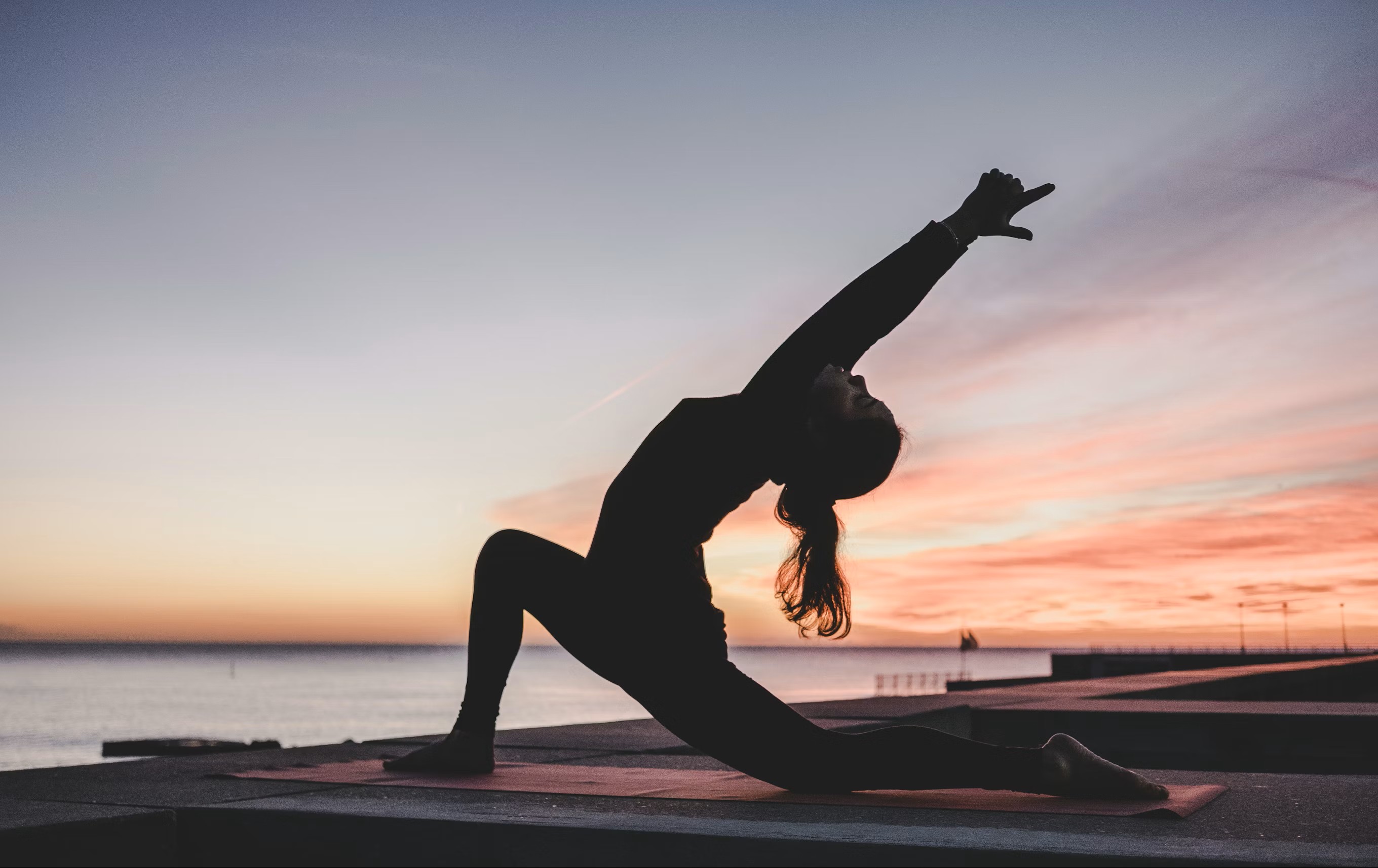 Silhouette of a woman doing yoga