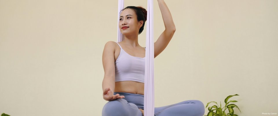 Practicing Aerial Yoga Poses with Calm Expression